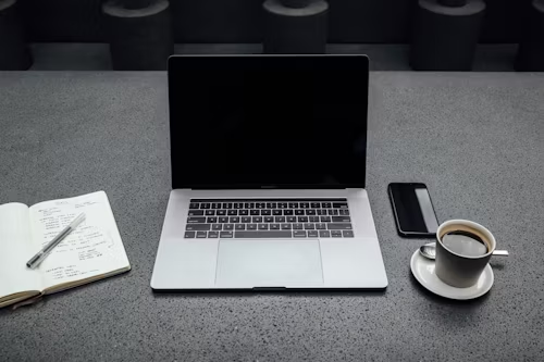 A laptop and a cup of coffee