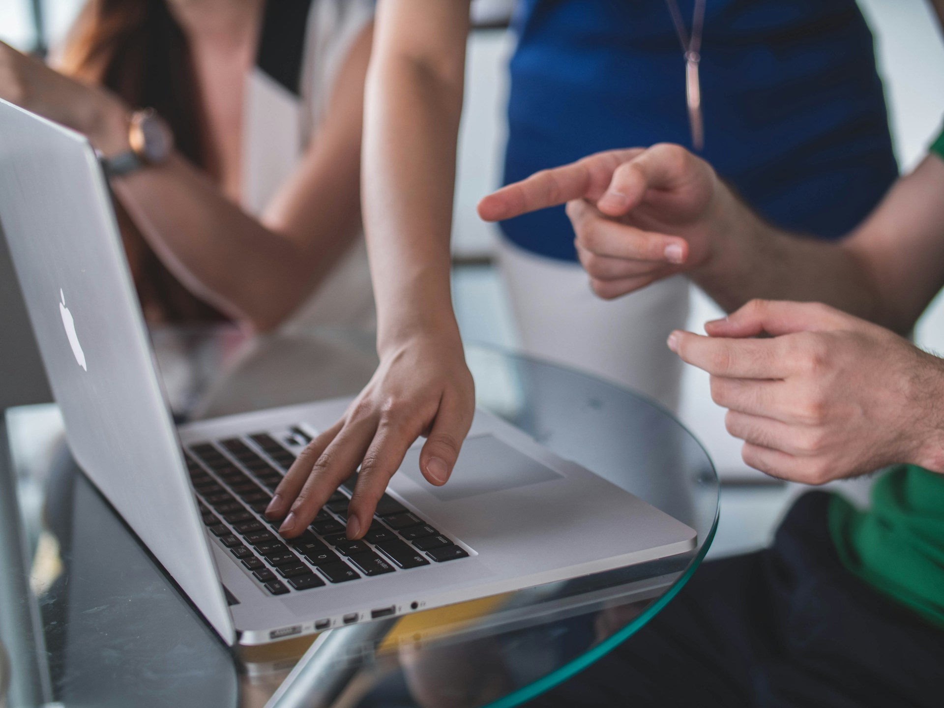 Person touching and pointing on a laptop