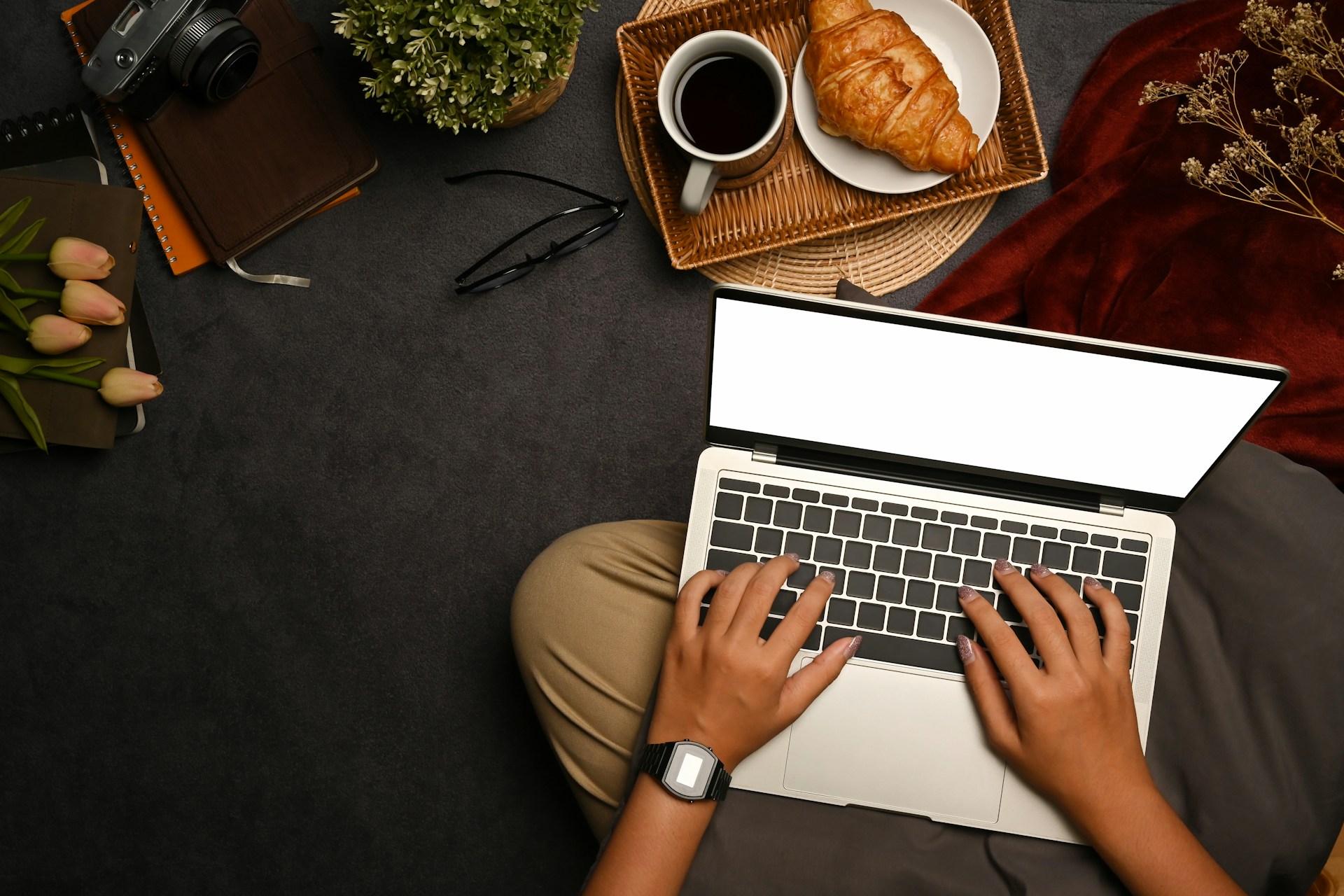 Person using a laptop with a bread on the side