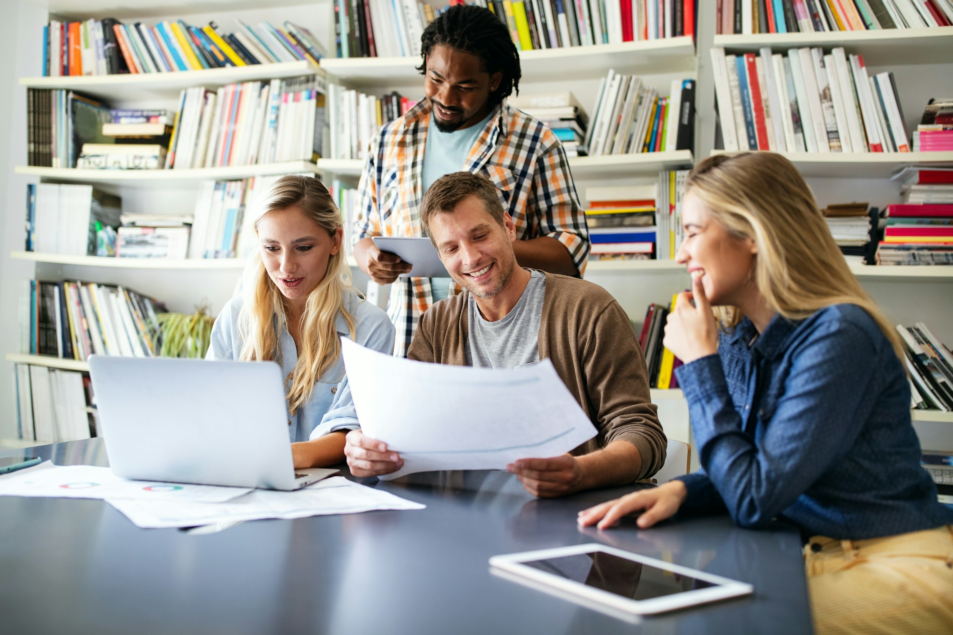 People talking while holding papers