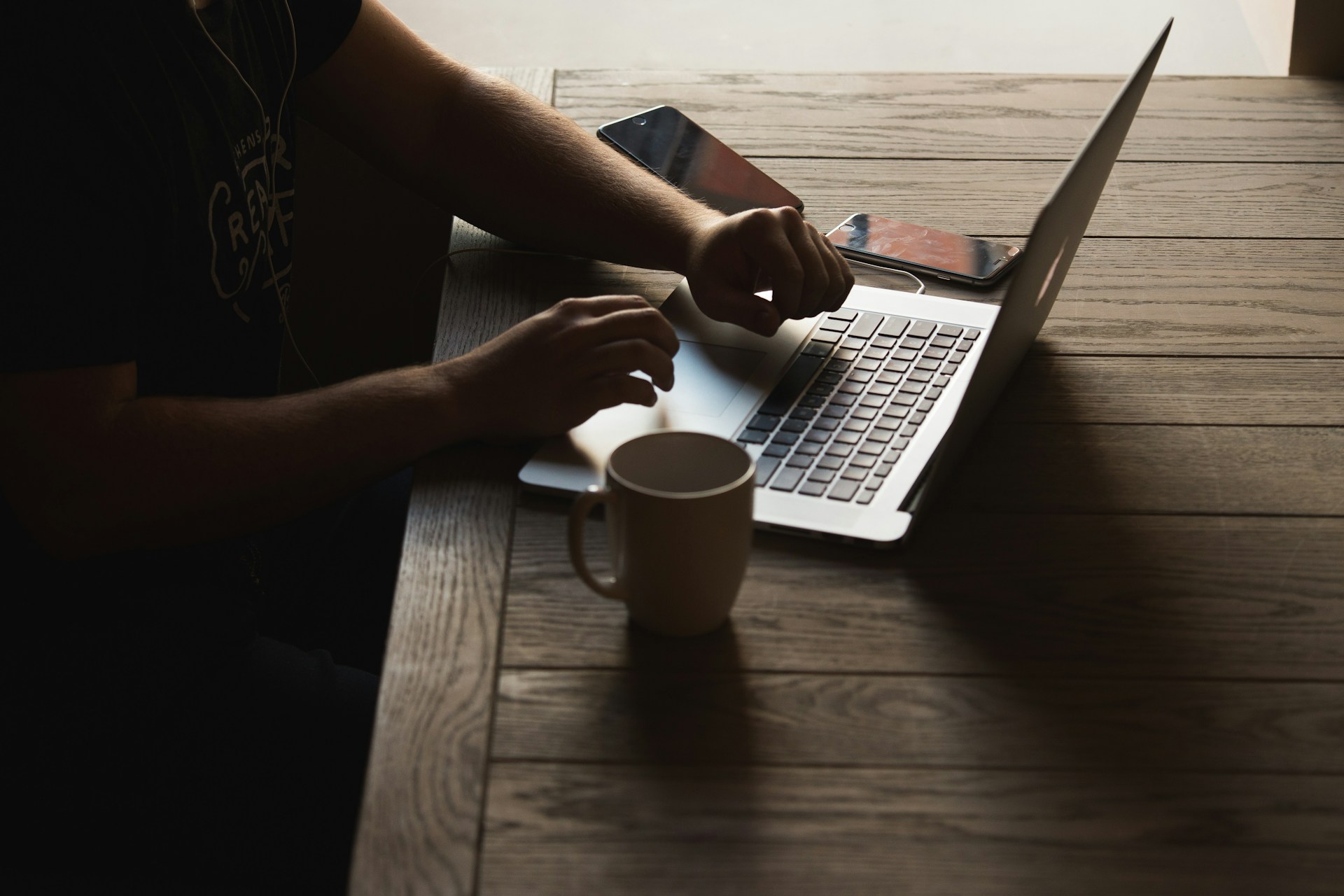 Gray laptop on a brown table