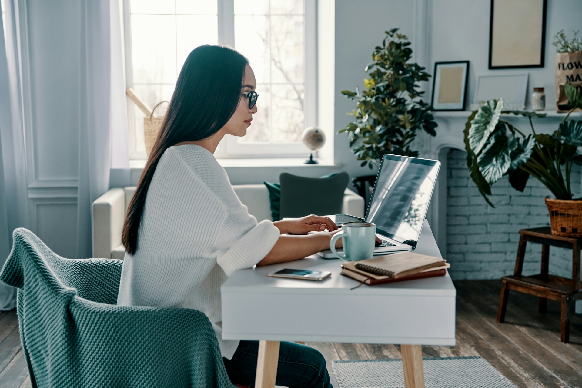 A person sitting in front of a laptop