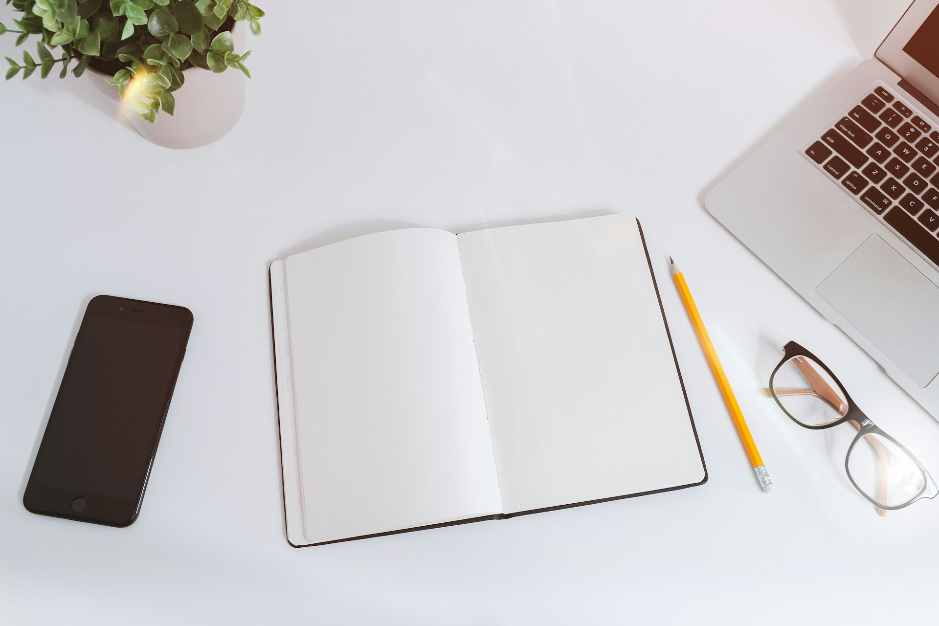 A notebook beside a laptop