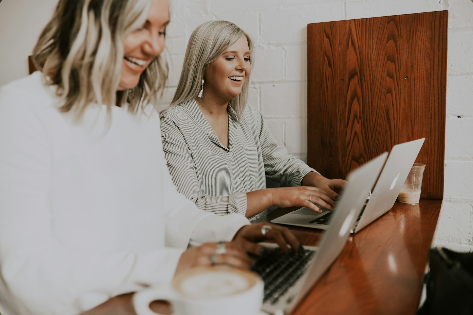 Two women using their laptops